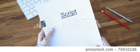 Screenwriter holds folder of documents labeled script 78910286