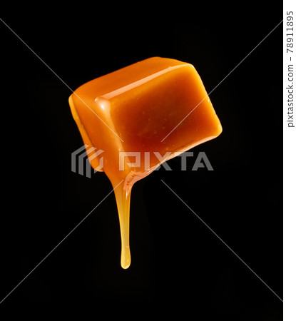 caramel sauce flowing on flying caramel candy 78911895