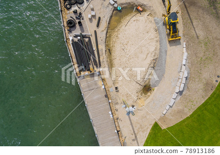 Under construction the pier is repair work several PVC sewer pipes Under construction the pier is repair work several PVC sewer pipes 78913186