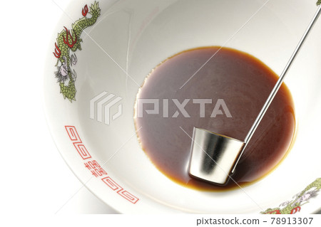 A white background shot of the ramen bowl with the original soy sauce ramen and ladle 78913307