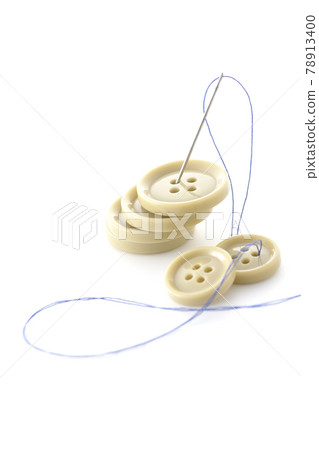Shoot buttons, needles and threads on a white background Shoot buttons, needles and threads on a white background 78913400
