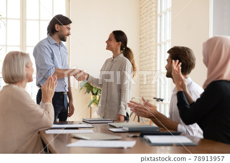 Confident executive shaking successful businesswoman hand at meeting 78913957