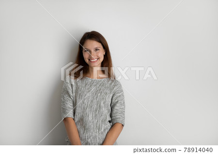 Portrait of happy beautiful woman on grey studio background 78914040