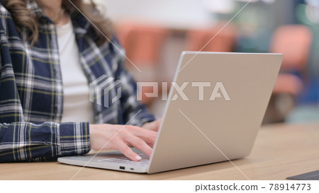 Female Hands Typing on Laptop Keyboard 78914773