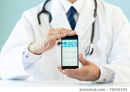 Hands of a doctor showing a smartphone app Hands of a doctor showing a smartphone app 78916193