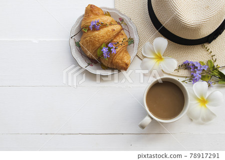 hot coffee, bread croissant and hat of lifestyle woman relax arrangement flat lay style hot coffee, bread croissant and hat of lifestyle woman relax arrangement flat lay style 78917291