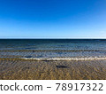 Sand beach, sea water waves and beautiful blue sky at Brighton beach in Melbourne, Australia. 78917322