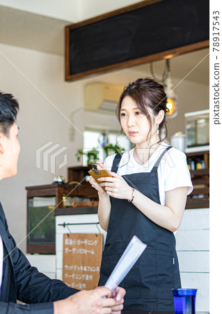 Female and male customers taking orders at the cafe 78917543