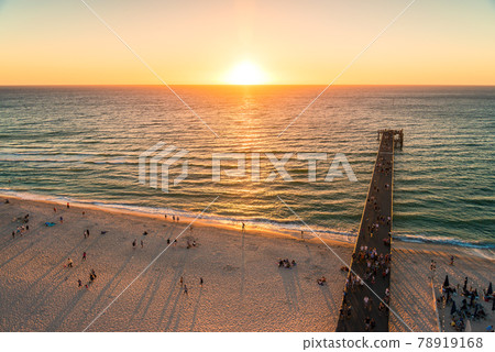 Glenelg beach jetty with people at sunset Glenelg beach jetty with people at sunset 78919168