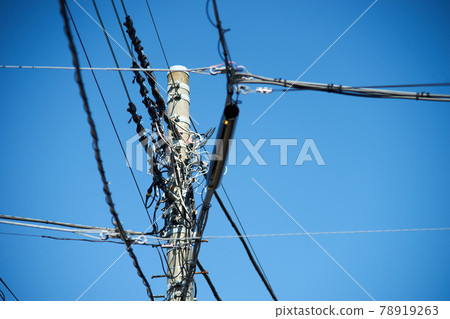 Telephone poles, various cables, ups, fine weather 78919263