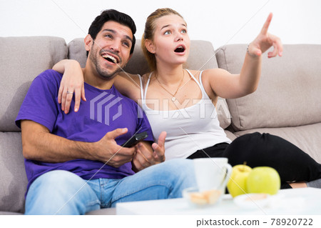 Loving couple on sofa watching TV 78920722