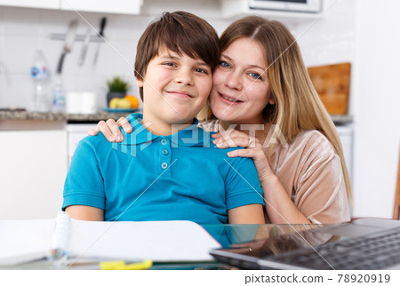 Family doing homework at kitchen 78920919