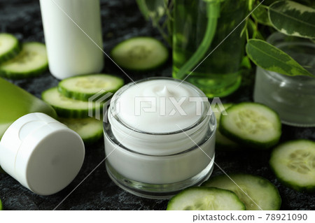Concept of cucumber cosmetics on black smokey table Concept of cucumber cosmetics on black smokey table 78921090