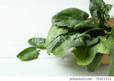 Bowl of spinach on white wooden background 78921331
