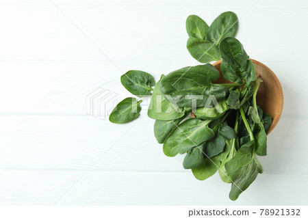 Bowl of spinach on white wooden background Bowl of spinach on white wooden background 78921332
