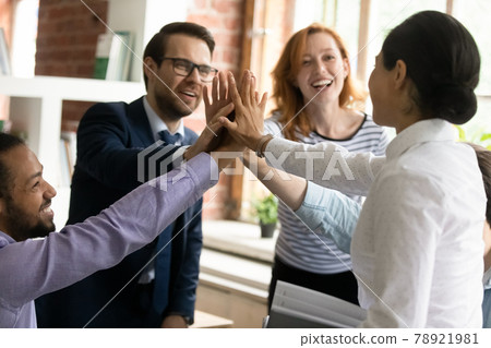 Happy successful multiracial colleagues giving high five, celebrating success. Happy successful multiracial colleagues giving high five, celebrating success. 78921981