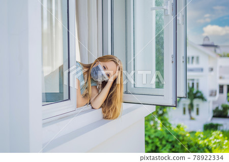 Extremly tired woman looking out the window, home alone. self-isolation at home, quarantine due to pandemic COVID 19. Mental health problems in self-isolation at home, quarantine, isolation, stay at 78922334