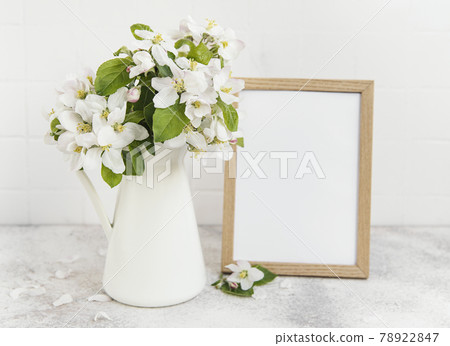 Spring apple blossom in a vase with an empty photo frame Spring apple blossom in a vase with an empty photo frame 78922847