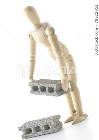 A drawing doll carrying a concrete block is photographed on a white background. A drawing doll carrying a concrete block is photographed on a white background. 78922952
