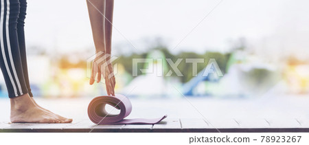 Banner Woman hands rolled up yoga mat outdoor workout. Panoramic hands rolling foam yoga gym mat morning exercise. Woman stretching workout healthy lifestyle on street city town park with copyspace Banner Woman hands rolled up yoga mat outdoor workout. Panoramic hands rolling foam yoga gym mat morning exercise. Woman stretching workout healthy lifestyle on street city town park with copyspace 78923267