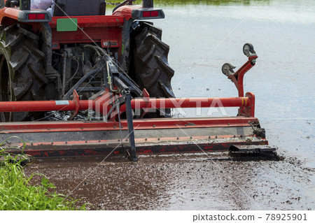 Agricultural machinery tractor preparing for rice planting 78925901