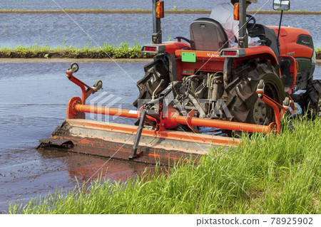 Agricultural machinery tractor preparing for rice planting Agricultural machinery tractor preparing for rice planting 78925902