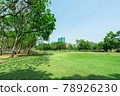 City park under blue sky with building background 78926230