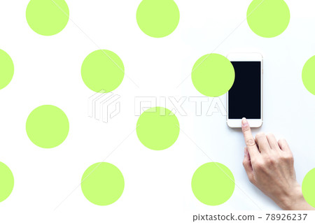 Female hand operating a smartphone Polka dot green 78926237