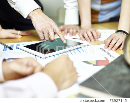 group of asian people meeting in office discussing business plan using tablet computer. group of asian people meeting in office discussing business plan using tablet computer. 78927145