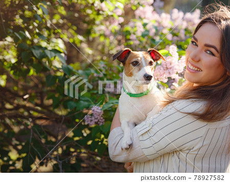 Young woman with her cute Jack Russell Terrier outdoor. 78927582