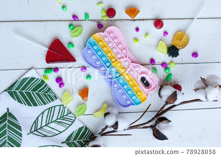 Phone case with pop it on white wooden background 78928038