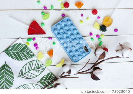 Phone case with pop it on white wooden background 78928040