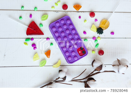 Phone case with pop it on white wooden background 78928046