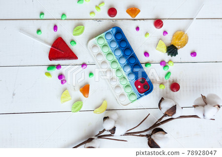 Phone case with pop it on white wooden background Phone case with pop it on white wooden background 78928047