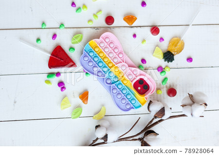 Phone case with pop it on white wooden background 78928064