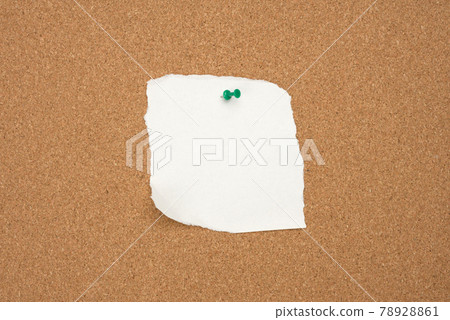 torn white blank white sheet of paper affixed with a plastic button on a brown cork board 78928861
