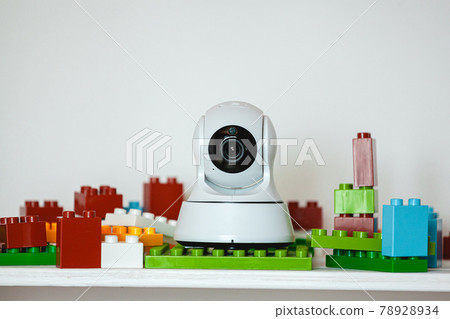 IP camera on the shelf with toys, serving as baby monitor IP camera on the shelf with toys, serving as baby monitor 78928934
