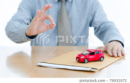 A Businessman sent filing for car loan. document and small red car A Businessman sent filing for car loan. document and small red car 78932072
