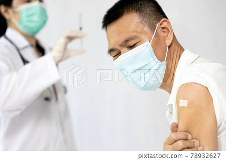 Refuse the vaccination during illness,Sick middle aged man have a fever,shoulder arm pain after injection at first dose of Coronavirus vaccine,preparing to receive a second dose of COVID-19 vaccine 78932627