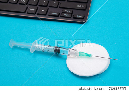 Vaccination or Revaccination Concept - A Medical Syringe on Blue Table 78932765