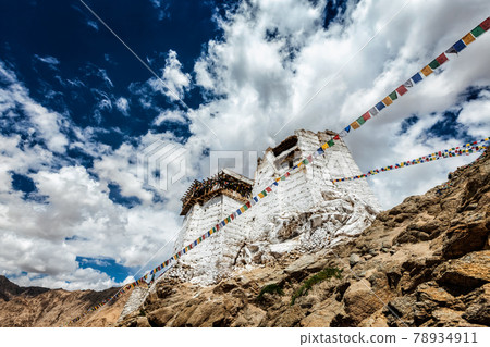 Ruins of Tsemo Victory Fort on the cliff of Namgyal hill and Lungta - colorful Buddhist prayer flags Ruins of Tsemo Victory Fort on the cliff of Namgyal hill and Lungta - colorful Buddhist prayer flags 78934911