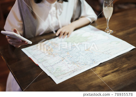 A young woman looking at a map in a fashionable space 78935578