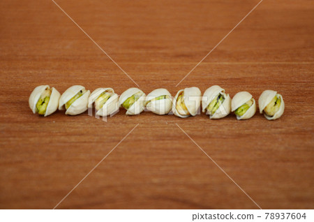 Salted pistachio nuts on wood texture background.    78937604