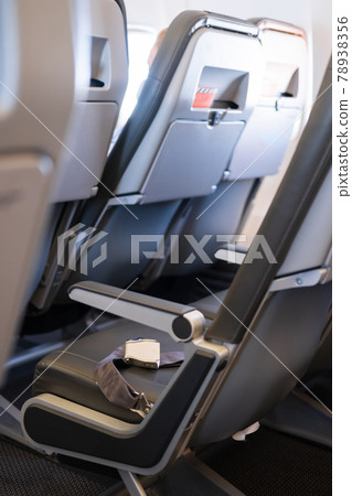 Interior of an empty airplane. Empty aircraft seats with seat belts 78938356