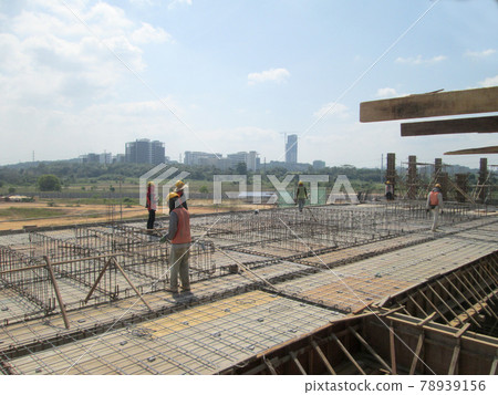 MALACCA, MALAYSIA -JANUARY 14, 2017: Construction workers install and fabricating floor slab reinforcement bar at the construction site. The reinforcement bar is tie together using tiny wire.  78939156
