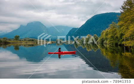 Adventure Caucasian Adult Woman Kayaking in Red Kayak Adventure Caucasian Adult Woman Kayaking in Red Kayak 78941353