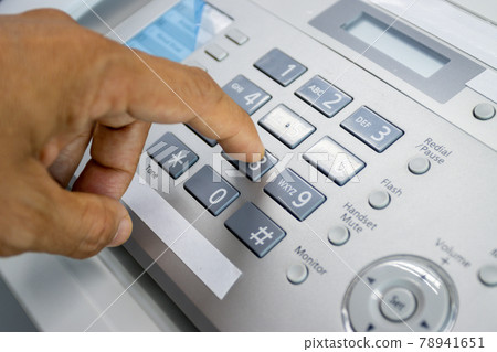 hand man are using a fax machine in the office, equipment for data transmission. 78941651