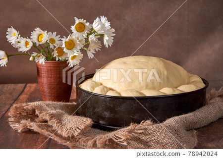 Dough for a festive cake on a wooden table. Preparation of dough for wedding loaf Dough for a festive cake on a wooden table. Preparation of dough for wedding loaf 78942024