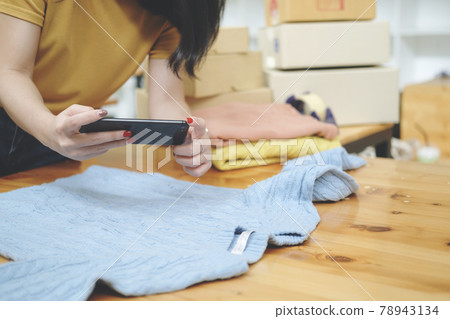 Online seller owner take a photo of product for upload to website online shop. Online seller owner take a photo of product for upload to website online shop. 78943134