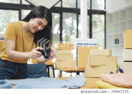 Online seller owner take a photo of product for upload to website online shop. Online seller owner take a photo of product for upload to website online shop. 78943135